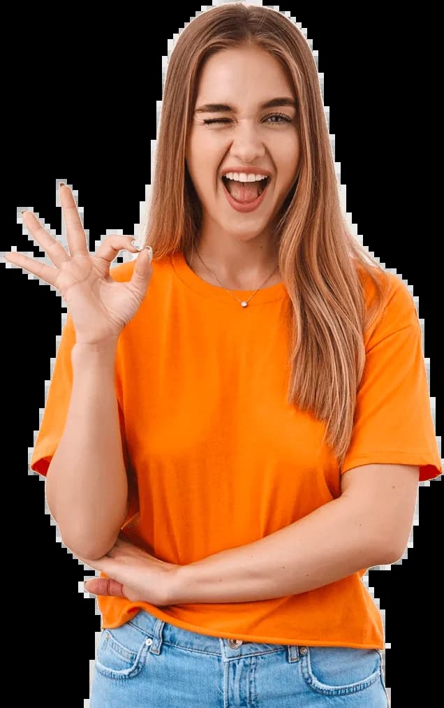 A smiling woman in an orange sweater looking forward to her next chapter