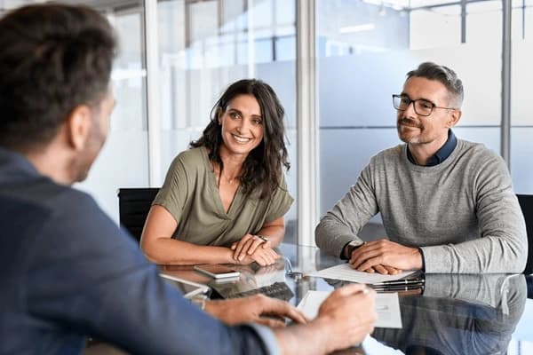 A couple discussing their financial plans with an adviser